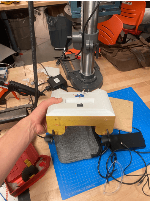 Handheld prototype with motors running and propellers spinning on the bench