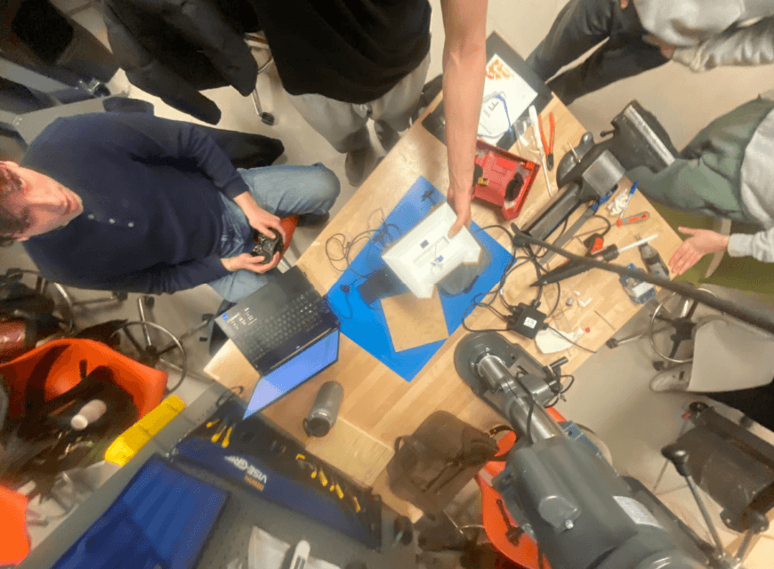 Team wiring electronics and testing Bluetooth controller at the workbench